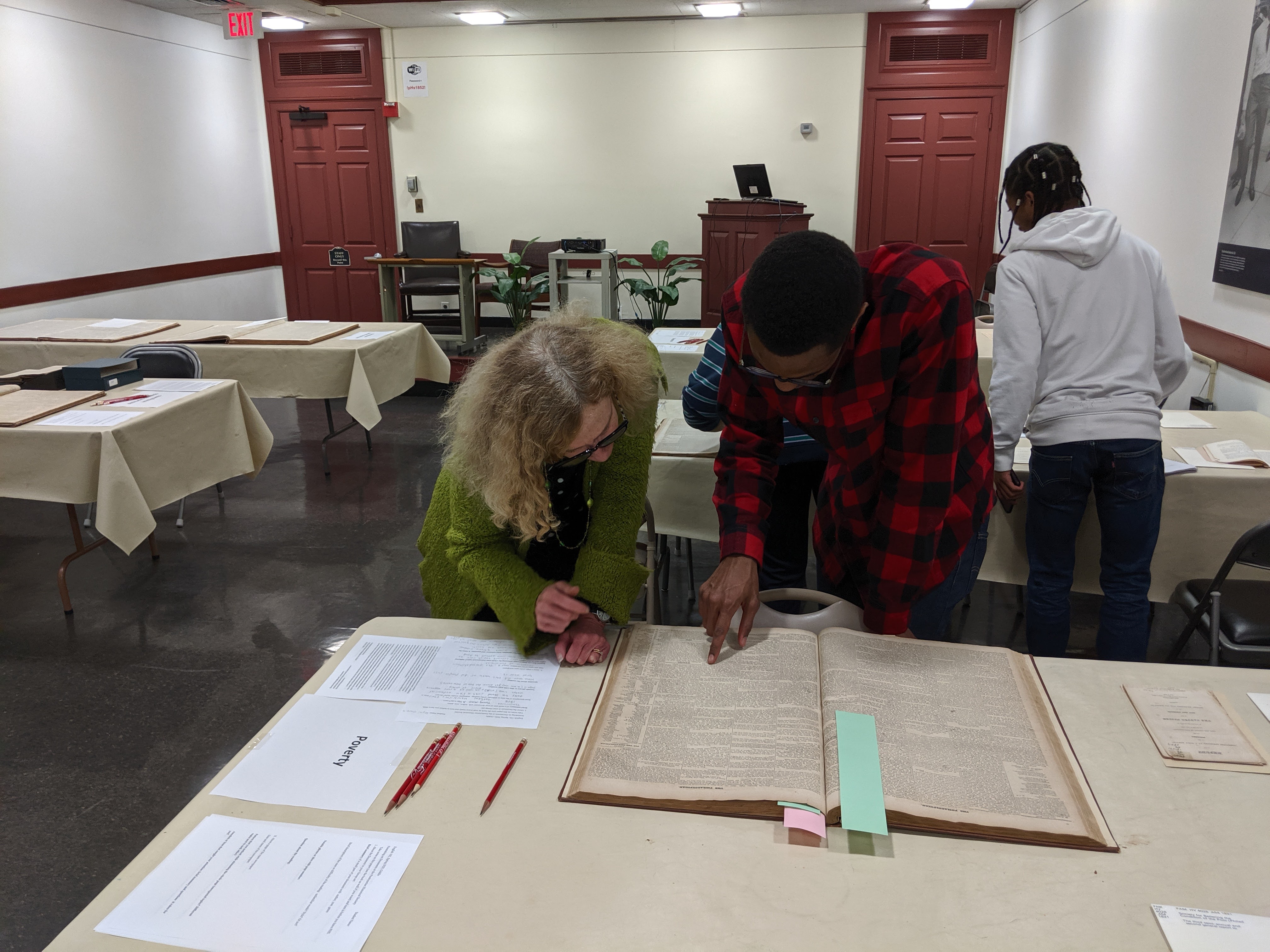 Cindy Giddle and student looking at sources