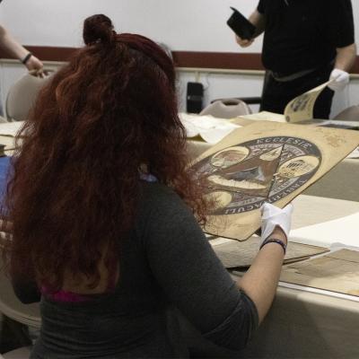 Student holding archival item